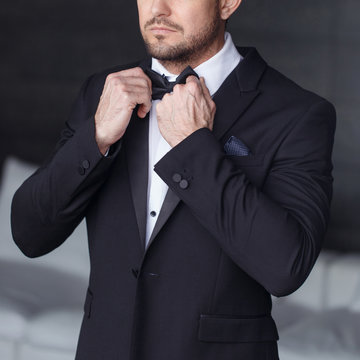 Sexy man dressing tuxedo and suit closeup