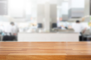 Empty wooden table and blurred kitchen background