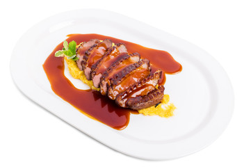 Grilled duck breast on mango puree.