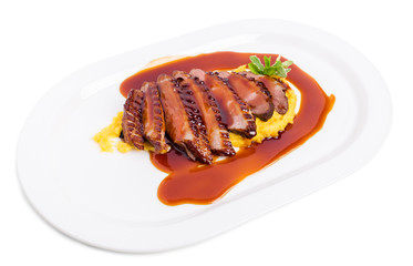 Grilled duck breast on mango puree.