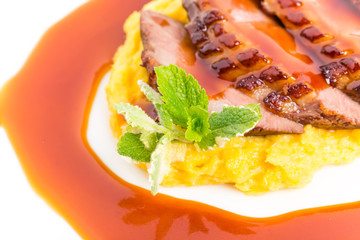 Grilled duck breast on mango puree.