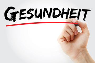 Hand writing Gesundheit (Health in German) with marker, health concept background