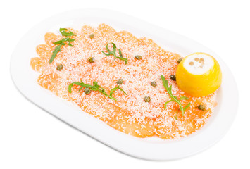 Appetizing salmon carpaccio with arugula.