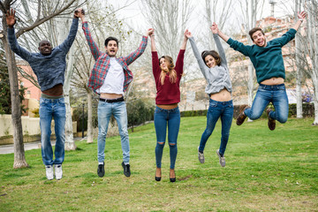 Obraz premium Group of young people jumping together outdoors