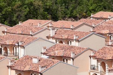 Fototapeta na wymiar Lots of houses with red-tile roofs viewed from above.