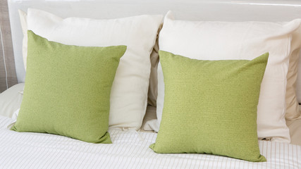 green pillows on a bed