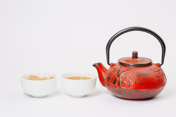 teacup with red cast-iron teapot