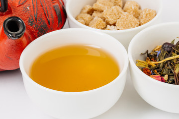 teacup with red cast-iron teapot