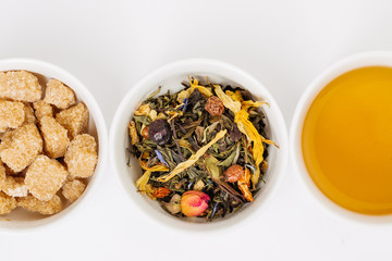 three cups of tea, tea leaves and sugar