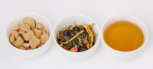 three cups of tea, tea leaves and sugar