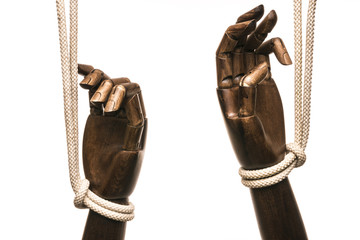 Black hands attached with white rope