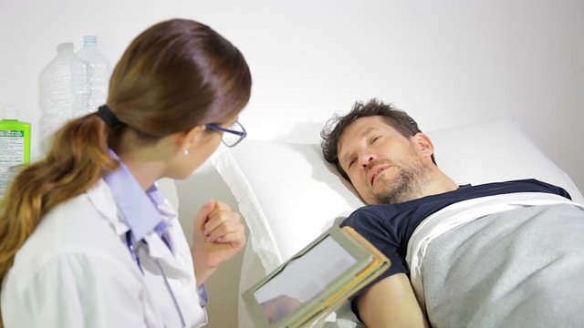 Sad Man Getting Bad News About Health In Hospital From Doctor Medium Shot