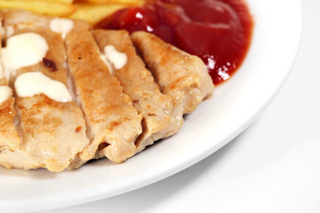 Fried pork / Fried pork and fried potatoes with ketchup on white plate.