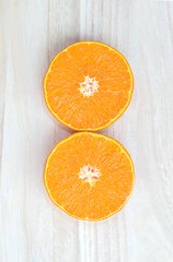 Orange fruit sliced on wooden background