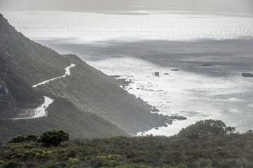 The mountain road on the ocean coast during rainy, wet weather.