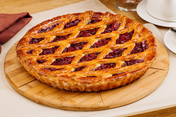 Homemade cherry pie on rustic background