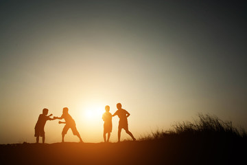 Fototapeta na wymiar Children playing on summer sunset happy time