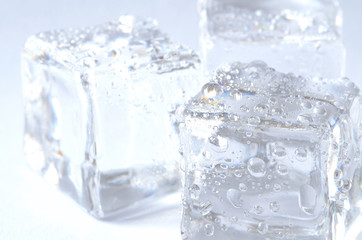 Macro of three ice cubes with water droplet