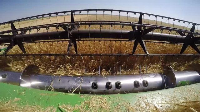 Khmelnitskiy, Ukraine - July 23: Modern John Deere combine harvesting grain in the field near the town Khmelnitskiy