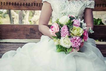 beautiful bouquet of different colors in the hands of the bride