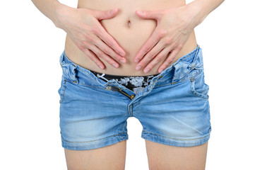 Woman's hands cover her stomach in pain