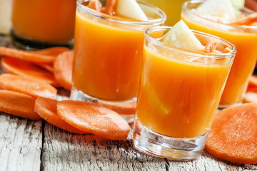 Apple-carrot fresh smoothies, vintage wooden background, selecti