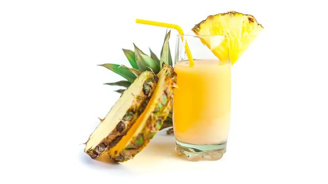 Glass of fresh pineapple juice with two slices of pineapple on white isolated background