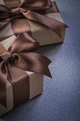 Composition of giftboxes in brown paper on grey background celeb