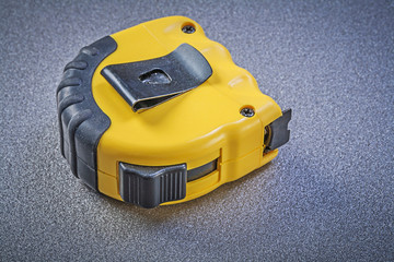 Fototapeta premium Tape-measure on grey background construction concept