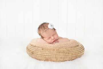 sleeping newborn baby in a basket