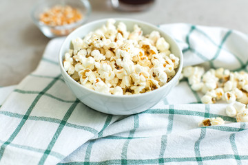 bowl of salty popcorn and soda