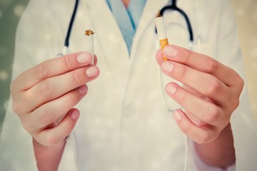 Composite image of doctor breaking cigarette