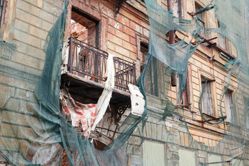 Facade is covered with green protection mesh