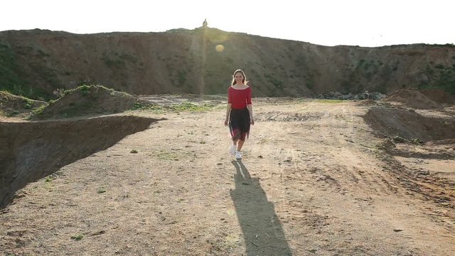 Girl walking on the sand pits.