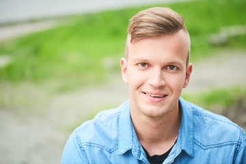 Portrait of a smiling student in a denim shirt