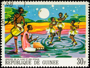 Three dancing black girls - scene from African Legends on postag