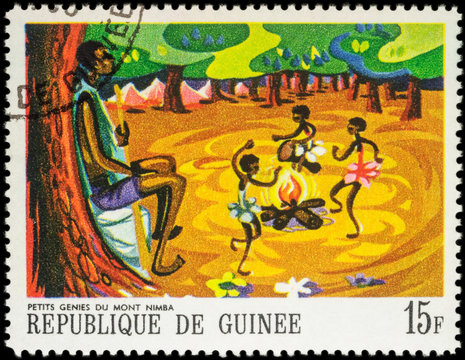 Little black girls dancing around the fire - scene from African