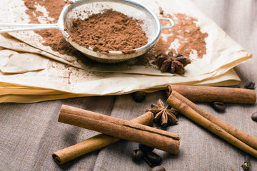 cinnamon, coffee beans, cocoa and anise on baking paper