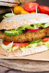 sandwich with fried meat and vegetables