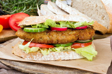 sandwich with fried meat and vegetables