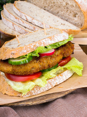sandwich with fried meat and vegetables