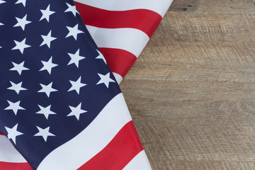 Obraz premium American flag folds on walnut wooden table. Horizontal image with copy space