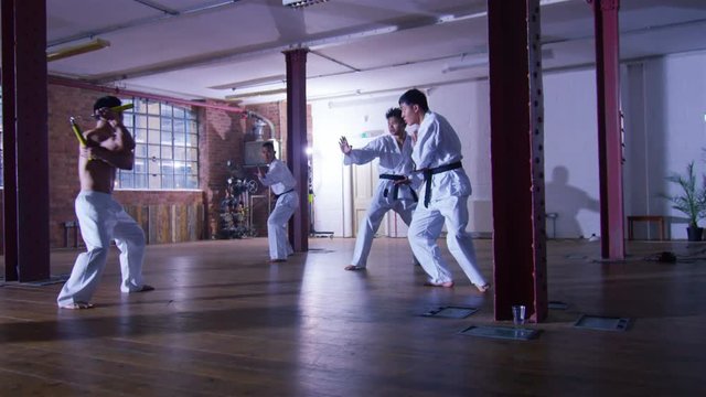  Outnumbered martial arts fighter skilfully uses nunchaku 