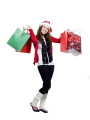 ecstatic young woman with shopping bags looking away.