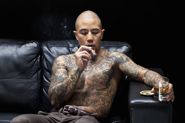 african american gangsta smoking and drinking. - obrazy, fototapety, plakaty