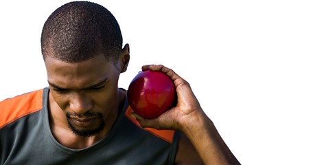 Portrait of sportsman practising shot put 