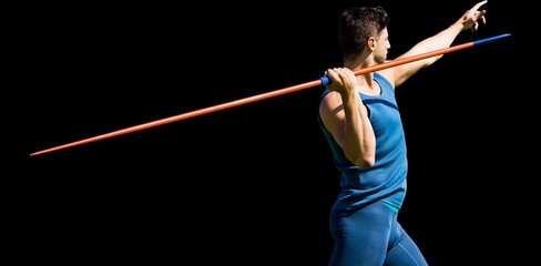 Rear view of sportsman practising javelin throw 