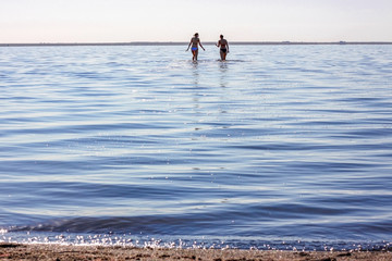 Fototapeta na wymiar Two women in lake with reflection