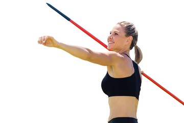 Portrait of happy sportswoman is practising javelin throw 