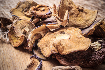 Dry mushrooms on wooden rustic table.